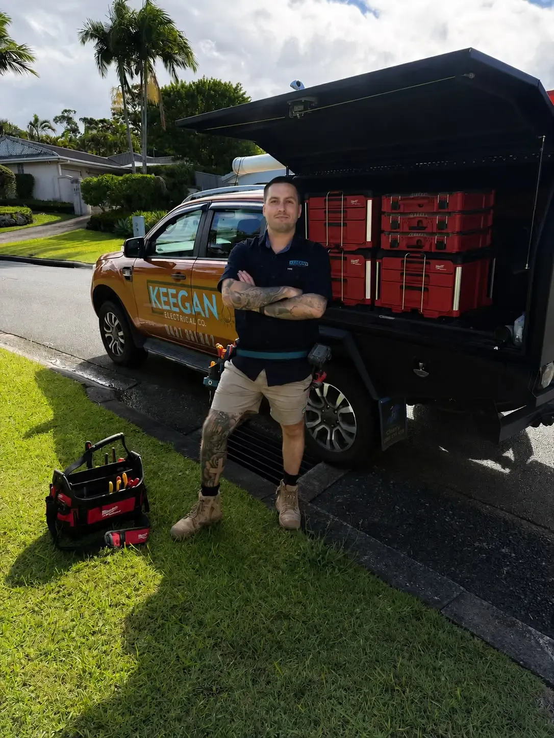 James Keegan standing beside his electrical work ute