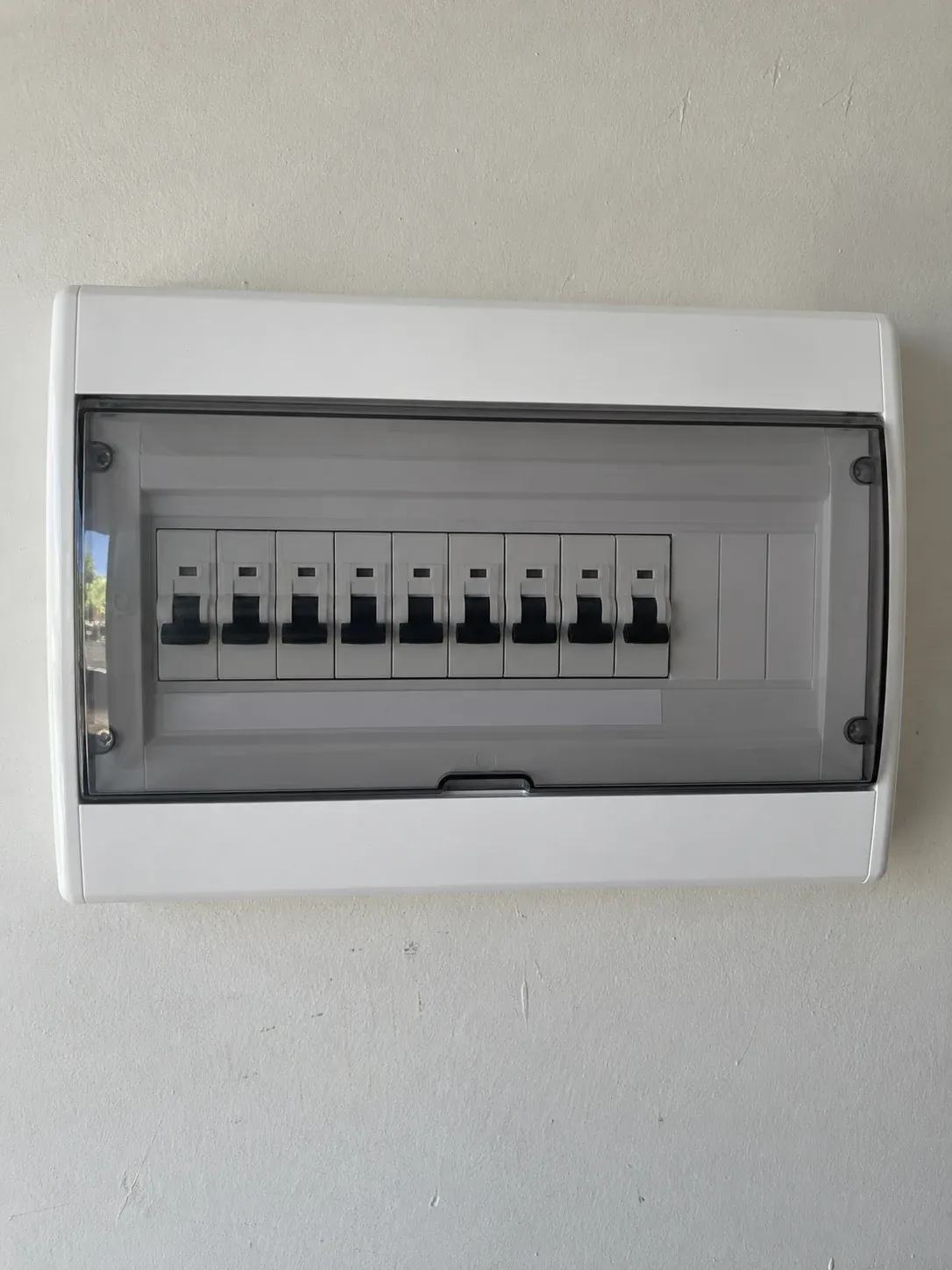 Domestic electrical panel behind a closed transparent cover