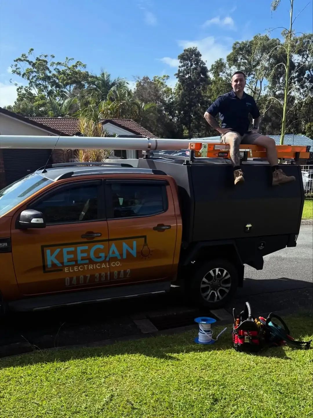 James beside the Keegan Electrical Co work ute