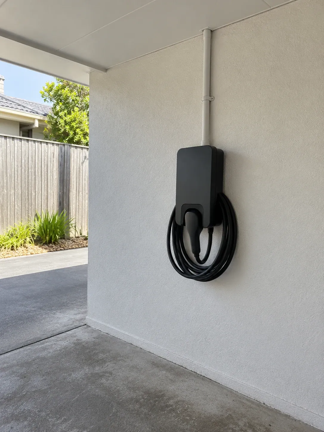 Wall-mounted EV charger under a covered carport