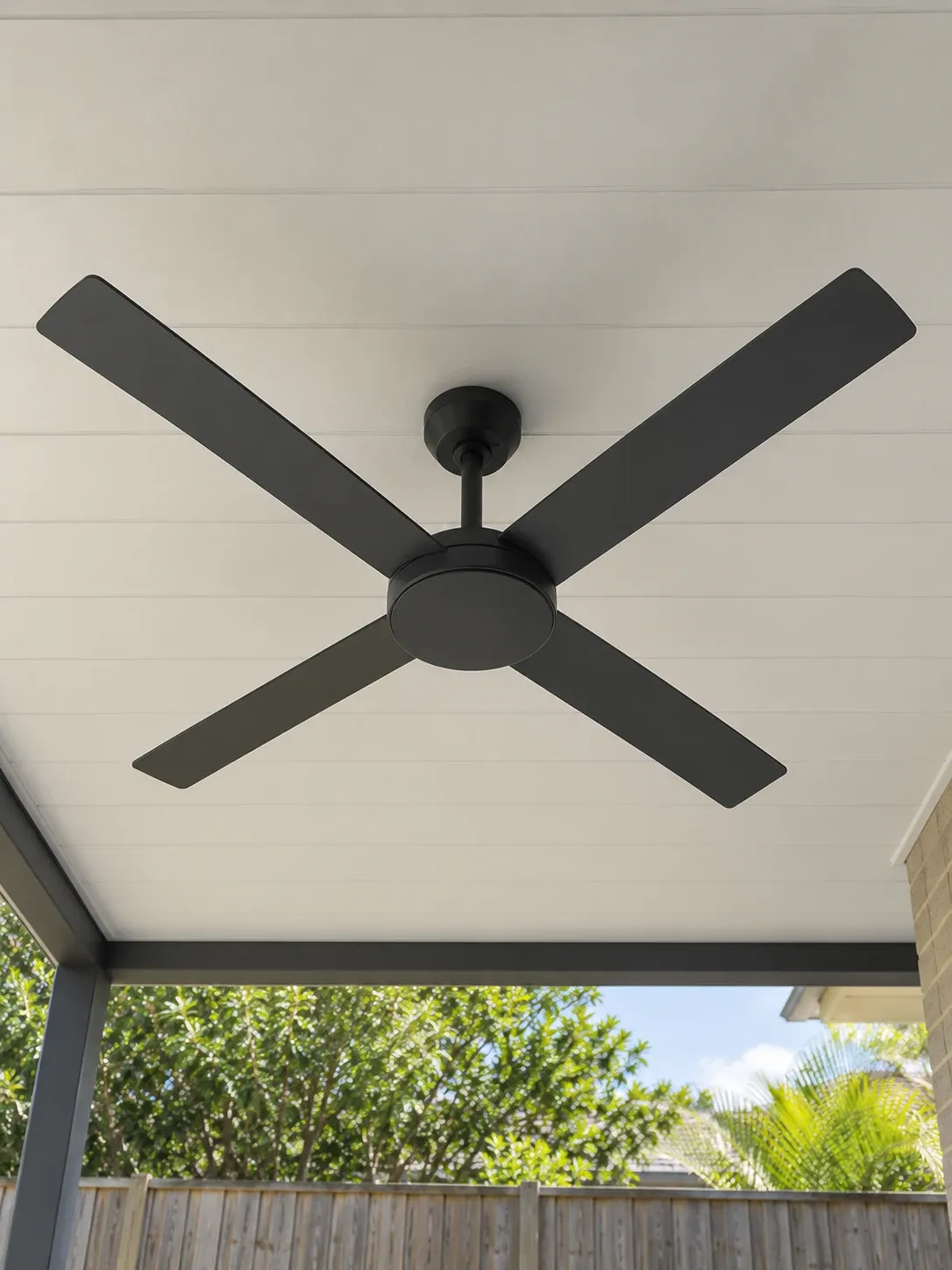 Charcoal four-blade fan under a covered patio