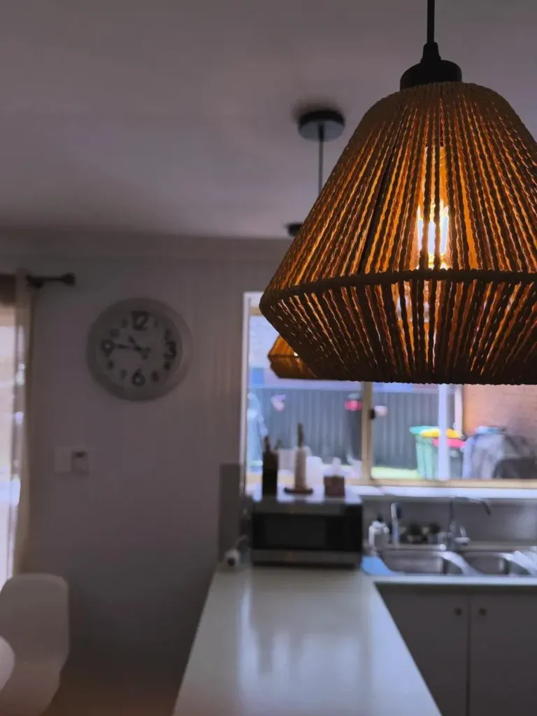 Woven pendant light above a kitchen bench